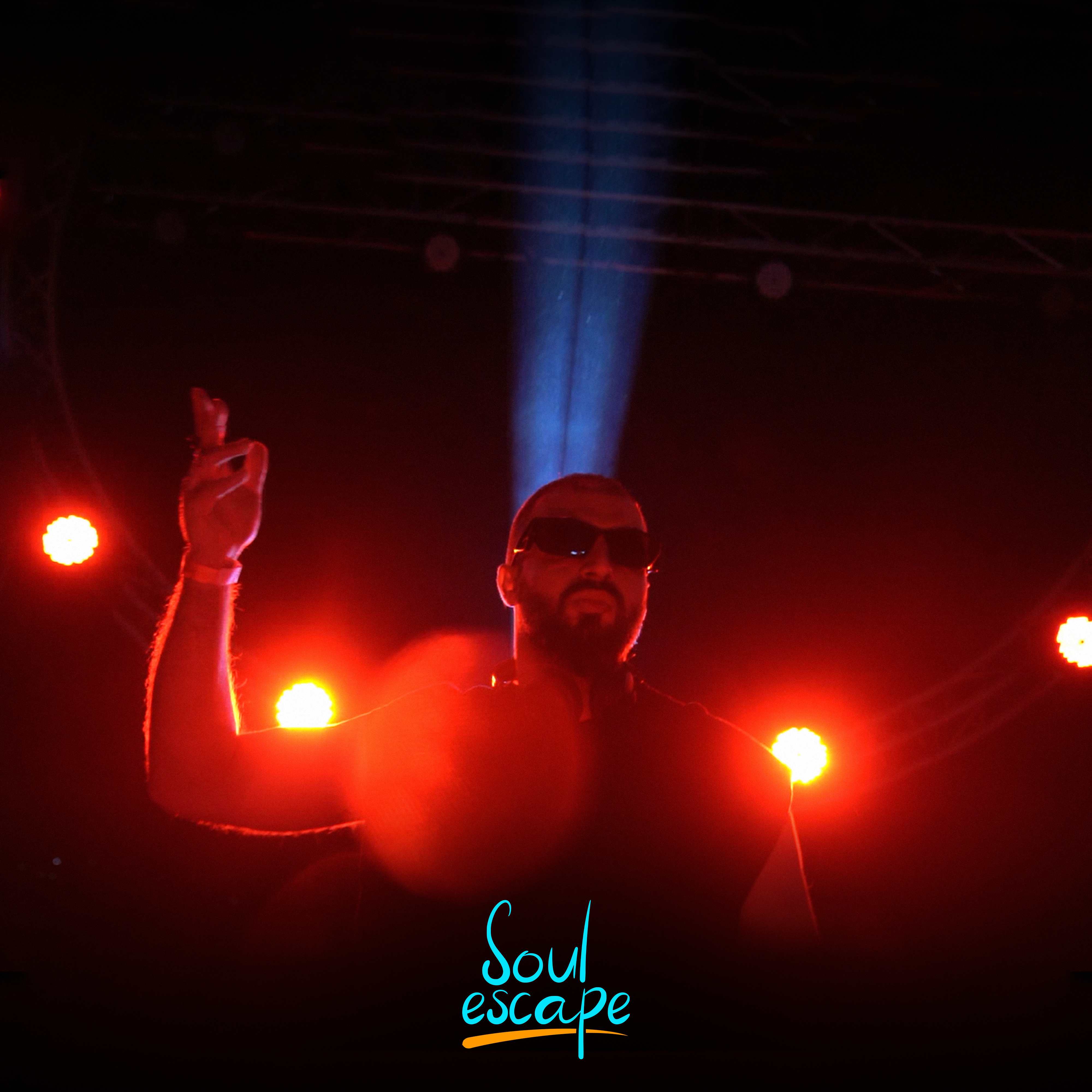 DJ performing with dramatic lighting at Soul Escape